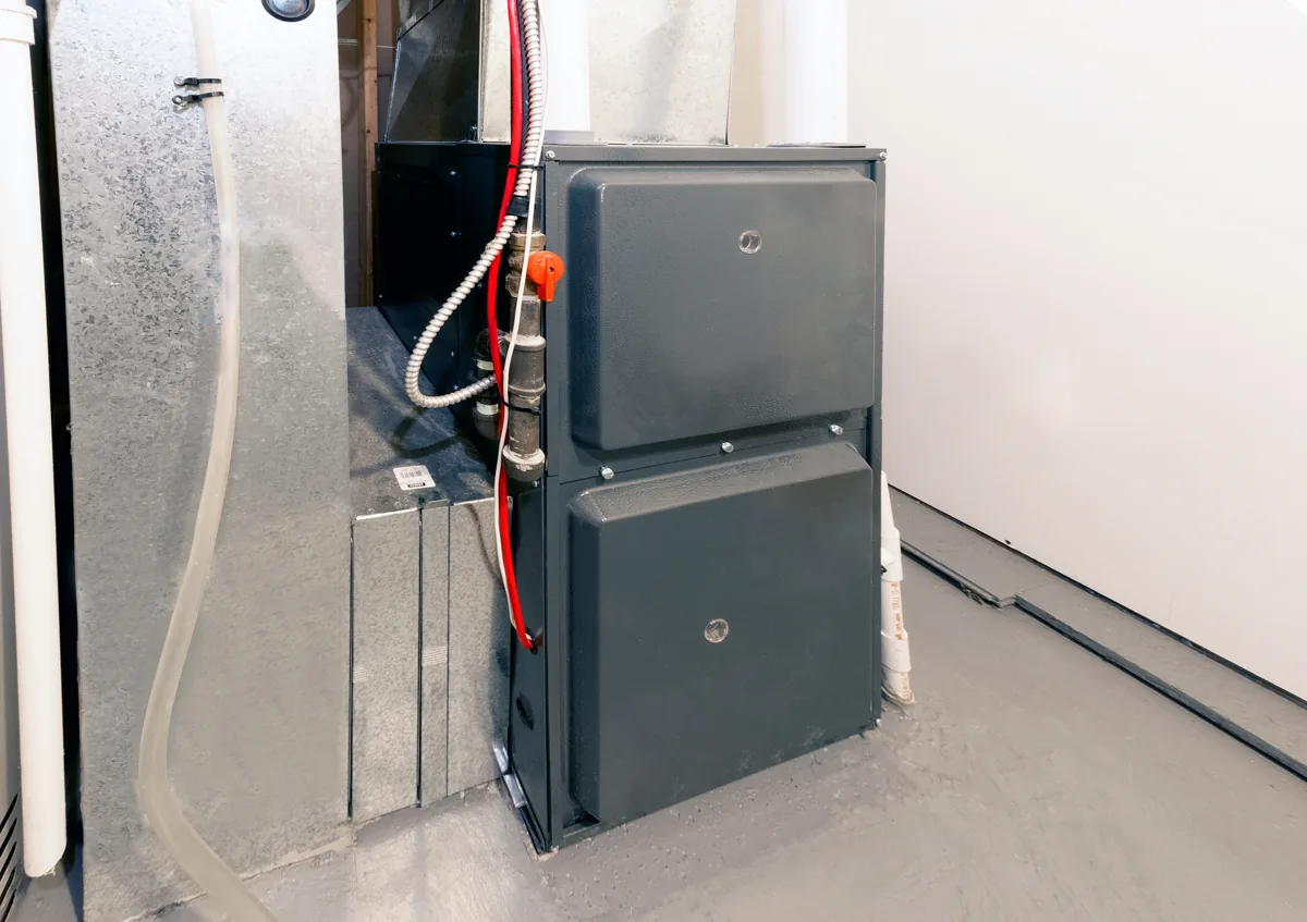 Residential furnace connected to ductwork in a basement
